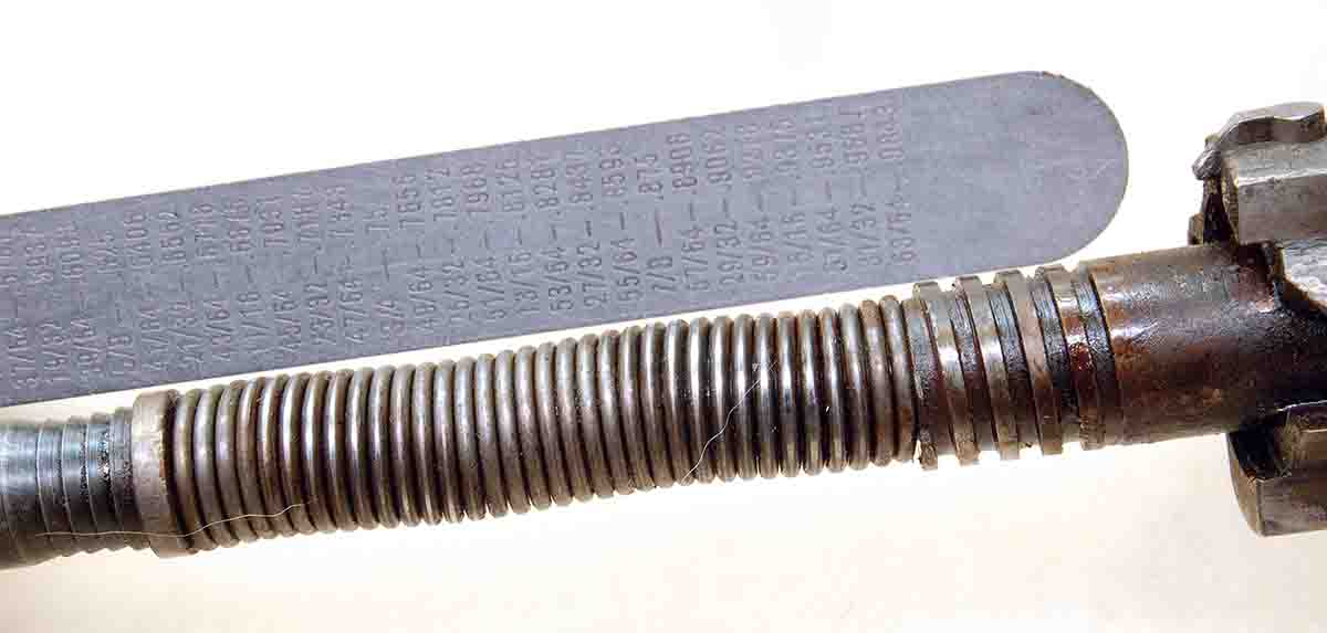 A compressed mainspring on a striker assembly shows the “bulges” that can drag on the inside of the bolt body when the rifle is cocked and when fired.